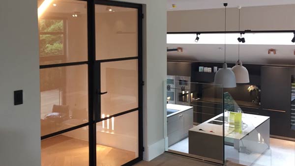 Internal Crittall screen installed on a project in Manchester. A matt black finish with matching hardeware adds an industrial edge to thie contemporary home. Horizontal glazing bars further enhance the look of this door.