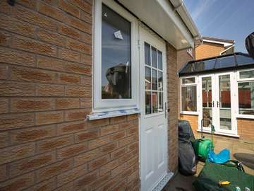 Back door replacement with composite with feature glazing bars and side window.