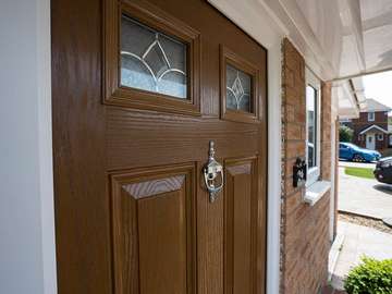Close up of door knocker and lead lights on this composite door installed in Ellesmere Port. Notice the wood grain effect throughout the door giving the look of timber with the low maintenance of UPVC.