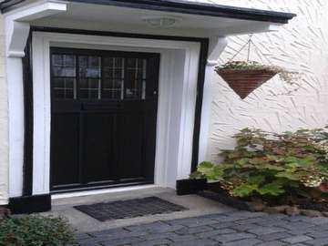 Traditional style timber alternative door in black with lead lighting from the English door company. Door recently fitted on the Wirral.