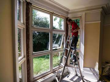 One of our installers putting the final touches on a large bay windows installation.