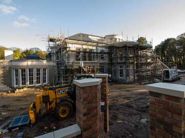 External shot of Formby mansion showing large glass installation nearing completion.