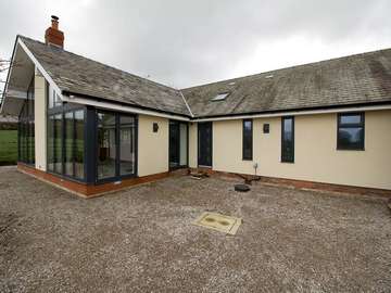 Photo shows original house with replacement windows and doors and new extension. All windows and doors supplied and installed by ourselves John Knight Glass.