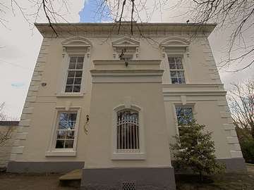 Close up of side entrance to property showing 5 extremely large sash windows with period correct glazing bars.