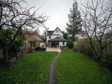 Rear view of full house featuing aluminium windows, bifold doors and roof lantern. Property is in Cheshire and has a large open plan living space flooded with light with the roof lantern and corner bifold doors.