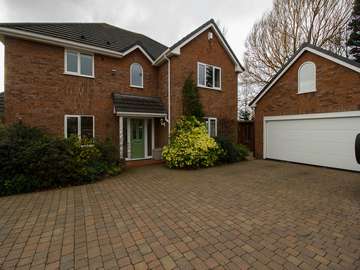 Full shot of house showing entrance door and UPVC windows installed throughout the house and garage.