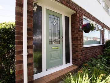 Portland Rockdoor in green, with dual frosted sidelights.