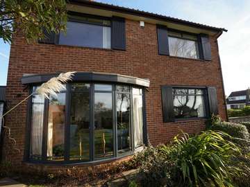 Close up of aluminium window installation showing feature rounded bay window.