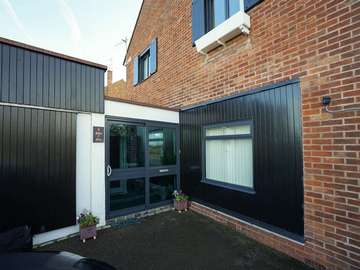 Sliding entrance door in Grey aluminium to match all windows installed throughout this installation.
