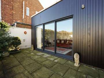 External view of triple pane aluminium sliding door to complete this brand new extension.
