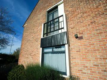 Grey aluminium windows fitted to the side of a traditional detached house in New Brighton, Wirral.