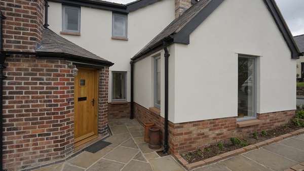 The entrance to this stunning home complete with verious portrait windows with a powder coated finish.