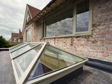 Installation of matching colour windows, doors and roof lanterns. The Roof lantern is all aluminium with self cleaning glass. The windows and doors are alu-clad timber from Rationel. 