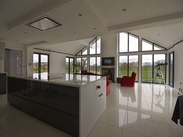 Alternative view showing kitchen/living space filled with natural light thanks to the large amoun of glazing. Unique top windows where custom made to fit this project.