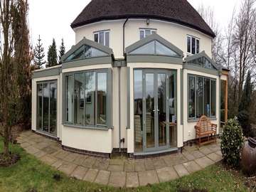 Unique large family open plan extension featuring lots of glazing products all working together to create a modern, large, light filled extension. All windows, doors and roof lights are powder coated aluminium in a light green colour.