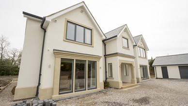 Close up of the front view of this large new build property featuring triple glazed alu clad windows and doors throughout.