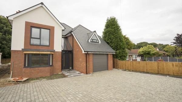 Bespoke front entrance shown on this build with a stuning glass roof and grey modern entrance door. Entrance door has been fitted with an oversized stainless steel handle.