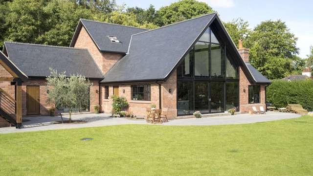 Close up of the main living area, black aluminium doors and Crittall windows contrast perfectly with the brickwork and roofing details.