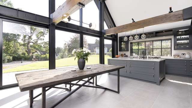 Internal view of the main living area featuring exposed metal beams which work extremely well with the industrial style Crittall products and black aluminium curtain walling.