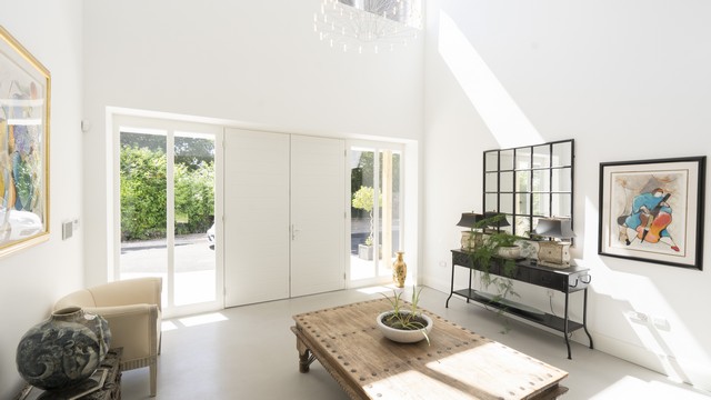 Internal view of a large dual timber entrance door with side lights.