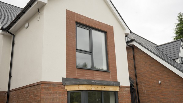 Triple pane aluminium window, sits well with the red brickwork and contrasting cream k-rend.