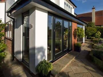 External shot of Rationel Timber/Aluminium French doors. External profile of windows and doors is black aluminium, internal profile is white timber creating a contemporary look externally with a warm homely feel to the interior.
