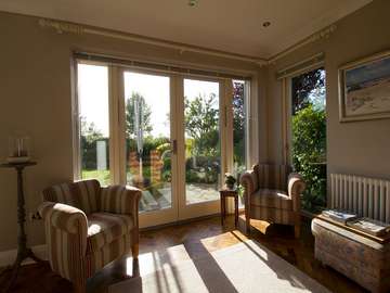 Internal shot of Rationel Timber/Aluminium French Doors and side windows. All glazing is triple glazed achieveing superior U values over traditional double glazed units.
