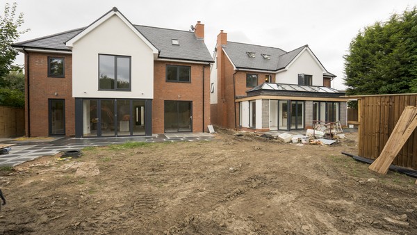 Alternative view showing both houses on this small housing develoment plot. Both houses have been fitted with aluminium windows and doors throughout, the house to the right features an orangery with aluminium roof lanterns and dual bifolding doors.