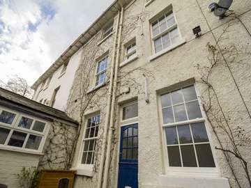 Rear view of property showing various smaler sash windows installed.