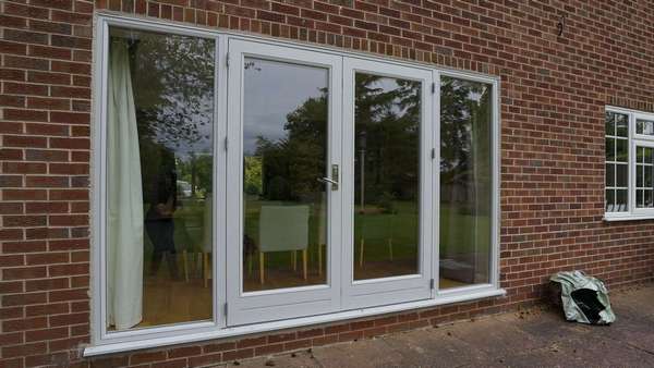 Close up of Rationel alu-clad french doors with side lights.