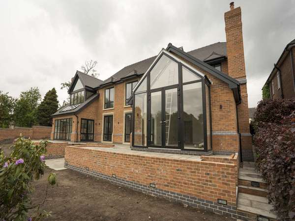 Rear view of this new build development featuring Crittall screen and aluminium windows and doors.