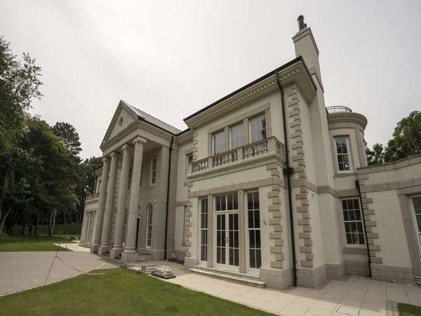 Front angle showing the various sliding sash windows and french doors. 