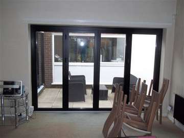 Mr & Mrs G . Heswall , Wirral : Installtion of Allstyle Alumnium slimfold Bi Folding doors. Marine finish Polyester Powder coated Satin Black. Example of aluminium triple glazed bi-fold doors. Aluminium bi-fold doors near Macclesfield SK11. Alumnus doors with 44mm triple glazing near Alderly Edge SK9. Aluminium Bi-fold doors near Wirral CH48 CH60. Alumnus Bi-fold doors triple glazed Liverpool Formby L37 near South Port PR8 Bi-fold doors near Crosby L23