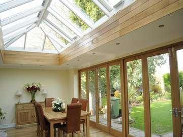 Cheadle Manchester. Internal view of a pair of G Barnsdale's Oak Bi Fold doors in there slimline section double glazed. Skylight HWL Ornate to complement the timber door. Marine Finish Aluminium with 4 no Rain censored Electric roof vents. 