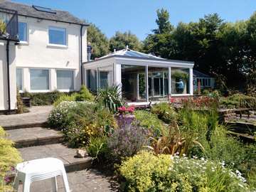 Mr & Mrs W. Caldy Wirral . Design and biuld . Orangery - K2 Roof system. Aluminium External cappings Glazed with Celsius one. Large Marine finish S Therm Sliding doors. Double glazed. Roof covering Sarnafil . Fascia Bespoke Timber to match house Cheshire skylights aluminium skylights Liverpool 