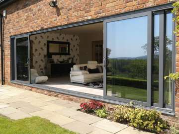 Mold , North Wales : Installation of Allstyle Multi Sliding Aluminium large Doors. Double glazed with Planitherm Low E Units 