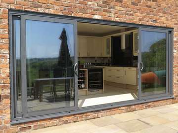 Mold , North Wales : Installation of a second set Allstyle Multi Sliding Aluminium large Doors. Double glazed with Planitherm Low E Units to the kitchen area 