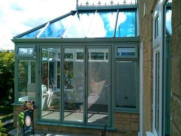Blackpool : Design and build PvcU Conservatory showing K2 Sage foil roof glazed with Hytherm Self Clean Double glazed units. Matching Sage Green foil PvcU window and Bi fold doors double glazed with Hytherm self cleaning double glazed units. 