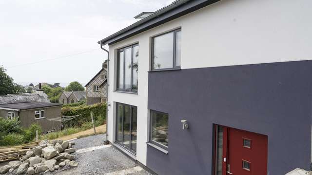 Another angle showing a glimpse of the view from this home in its elevated position. Large glazed doors at the front of the home take advantage of these impressive views of Cricceth beach.