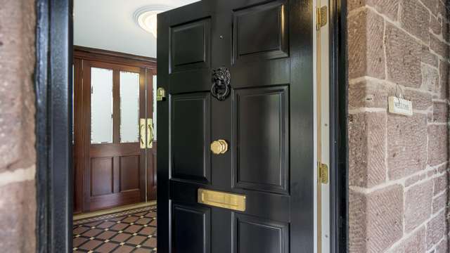 Black timber traditional entrance door with brass door furniture. Custom lion head door knocker in black to match the door colour.