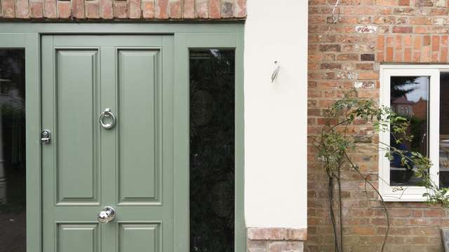 Close up of this stunning timber entrance door finish in matt green.