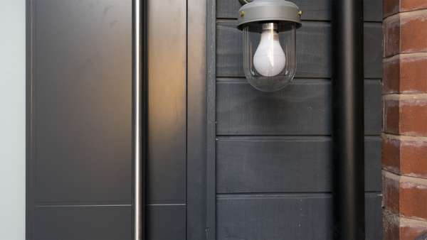 Close up details of the aluminium door with matching cladding.