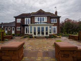 Straight on view of dual colour conservatory featuring Evolution windows.