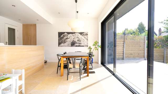 Straight on view of the dining area adjacent to the large sluminium sliding doors.