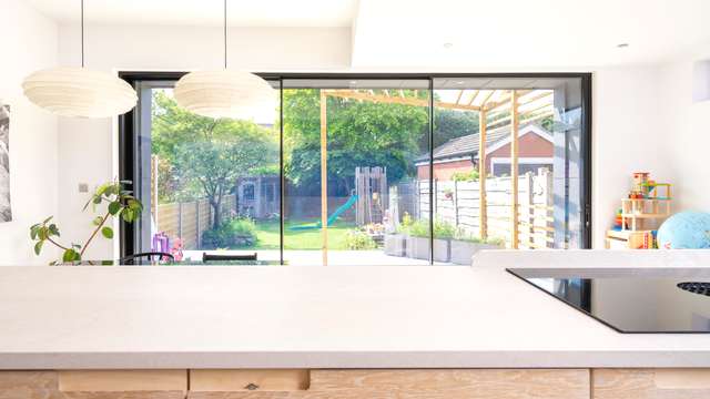 Internal view of the Knight Line sliding door in a triple panel configuration, highlighting the ultra thin mullion bars.
