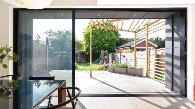 Straight on view showing the aluminium sliding door open. Notice the flush floor detail.