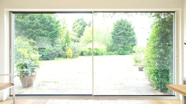 Internal view of a dual Knight Line aluminium sliding door in white.