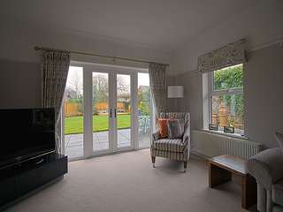 Interior shot of mock sash window and french door overlooking garden.