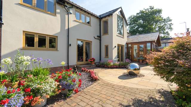 Alternative angle showing the UPVC timber alternative window and French door replacements.