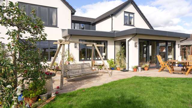 Alternative view of the rear of the property showing RAL7016 windows and door installation.